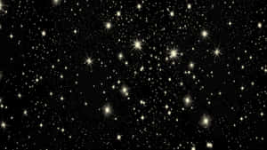 黑色背景上充滿發光金色星星的星空夜晚。