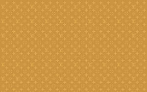 芥末色背景上的金色 Louis Vuitton 單字母組合圖案。