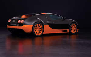 攝影棚內反光地板上的黑色和橙色Bugatti Super Sport跑車。