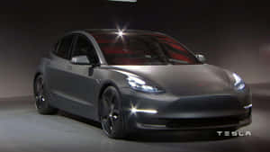 時尚的啞光灰色Tesla Model 3轎車，在攝影棚環境中帶有發光的車頭燈。 — Tesla GIF 壁紙