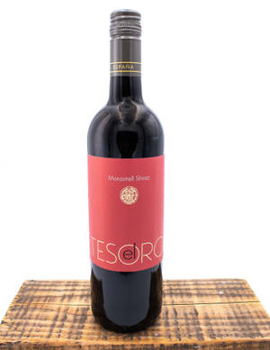 一個放在木質表面上的Tesoro Monastrell Shiraz紅酒瓶。