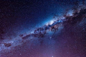 銀河系在繁星點點的夜空中散發出藍色和紫色色調。 — 銀河系 壁紙