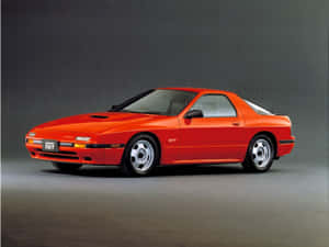 工作室中充滿活力的橙色Mazda RX7 GT跑車