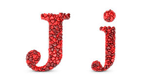 紅色心形石頭排列成大寫和小寫字母 J。