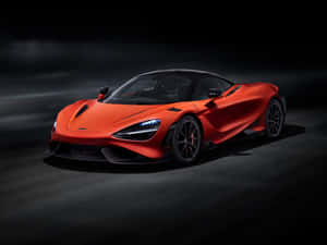 橙色McLaren超級跑車在黑暗的工作室中，車頭燈發光。 — 麥拿侖 GIF 壁紙