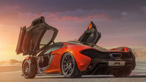 橙色McLaren P1超級跑車在日落時分的賽道上打開車門。 — 酷車 壁紙