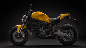 黃色Ducati電單車在攝影棚中，帶有黑色點綴和詳細的機械部件。