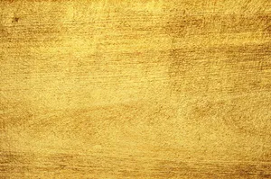 金色刷紋金屬紋理,帶有溫暖閃爍的高光。
