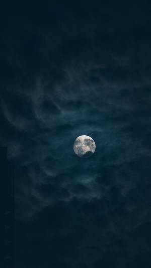 滿月夜間穿過烏雲閃耀。