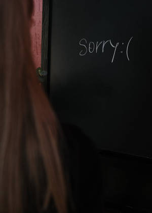 長頭髮嘅人望住一道寫住「Sorry :(」嘅門。 — 黑板 壁紙