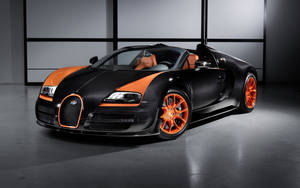 黑色和橙色Bugatti Veyron超級跑車在工作室中，帶有戲劇性的燈光。
