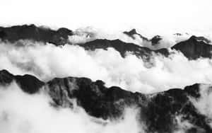 山峰從雲層中浮現，黑白風格