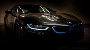 黑色BMW i8跑車在黑暗的攝影棚中發出藍色頭燈光芒。