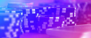 霓虹燈下遊戲桌上的藍色和紫色籌碼堆。 — 紫色美學 壁紙