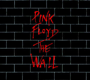 黑色磚牆上寫有 Pink Floyd The Wall 的紅色塗鴉文字。