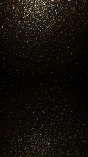深色背景上金色閃粉顆粒如星星般閃爍。