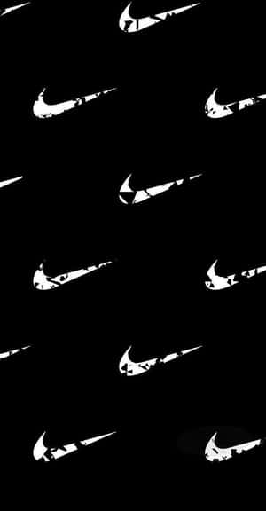 帶有磨損白色Nike swoosh標誌散落的黑色背景。