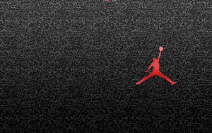 紅色籃球運動員標誌，置於有紋理的黑色背景上 — Air Jordan GIF 壁紙