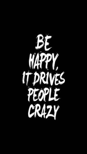 白色筆觸文字在黑色背景上寫著「Be happy it drives people crazy」。