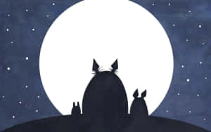 三個龍貓剪影在星空夜空中觀看滿月。