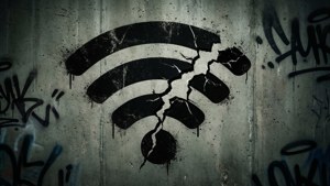 破裂的WiFi符號，畫在一個佈滿塗鴉的混凝土牆上。